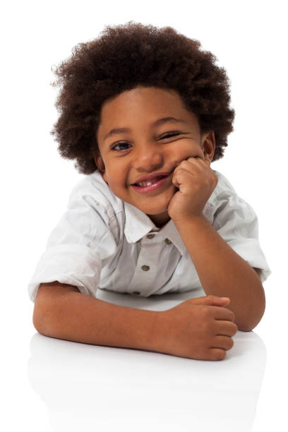 istock Playful african american little boy lying down on floor smiling at camera 1252756547