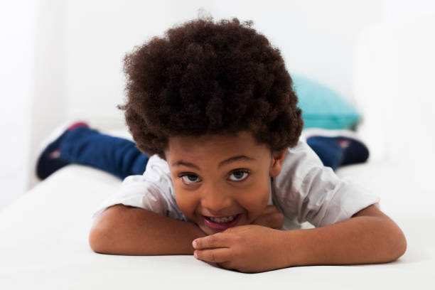 istock Relaxed african american little boy lying down smiling at camera 1252756570