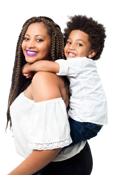 istock Beautiful black single mom carrying her son on back while both smiling at camera 1252756583