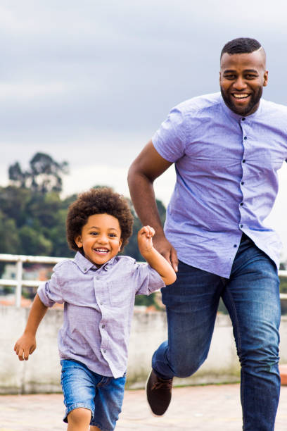 istock Happy boy and dad running outside 1252756593