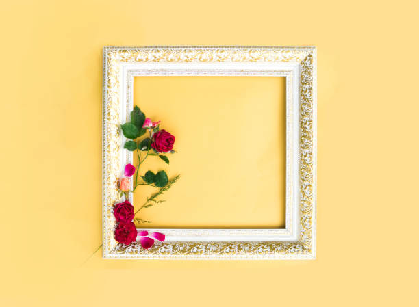 istock Flowers composition. Rose flowers and frame on yellow background. Flat lay, top view, summer concept 1252756639