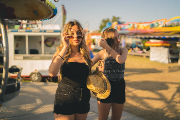 istock Happy girlfriends are make fun together in fun fair 1252757960