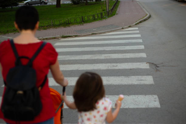 istock Mother with her children on crosswalk 1252758837