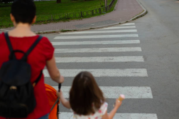 istock Mother with her children on crosswalk 1252758852