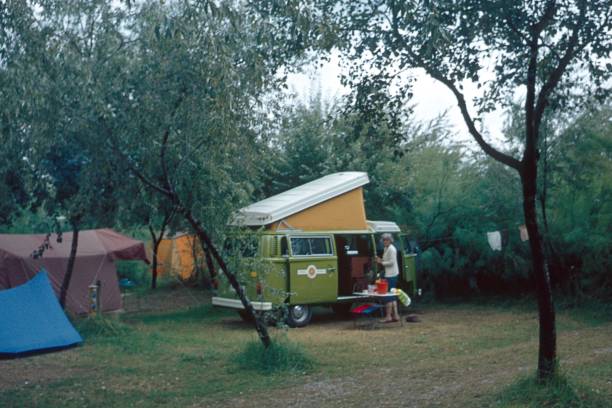 Germany (exact location unfortunately not known), 1978. Vacationer in front of her VW-BusT2 Westfalia on a camping site.
