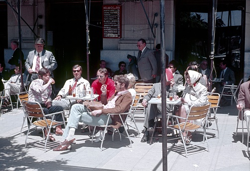 Northern Italy (exact location unfortunately not known), 1967. Street cafe (terrace) with locals and tourists in a northern Italian city.