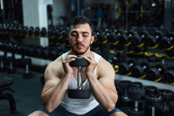 istock bodybuilder working out with dumbbells at the gym 1252763273