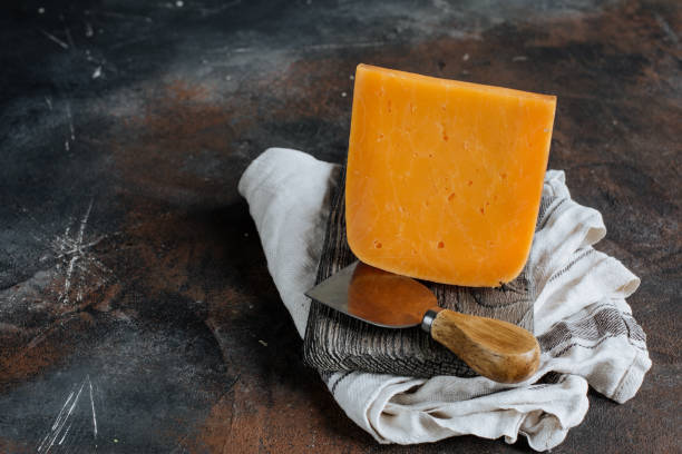 istock Cheddar cheese on a wooden Board 1252763451