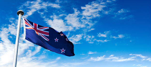 New Zealand flag on a blue sky.