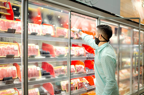 istock Young man shopping at grocery store using mask 1252764412