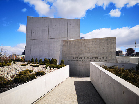 Ottawa, Canada - April 1, 2020: The striking angles of Canada's National Holocaust Monument create a contrast with the brilliant blue sky.  The monument was inaugurated in September 2017, and sits on the western edge of the downtown core on the LeBreton Flats.