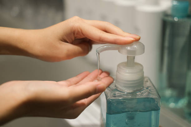 istock A girl using alcohol gel for cleaning hands 1252767257