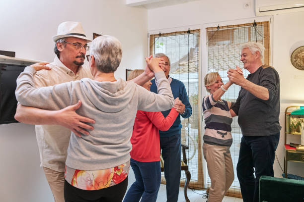 istock Cheerful senior couples having fun dancing tango at home 1252767296