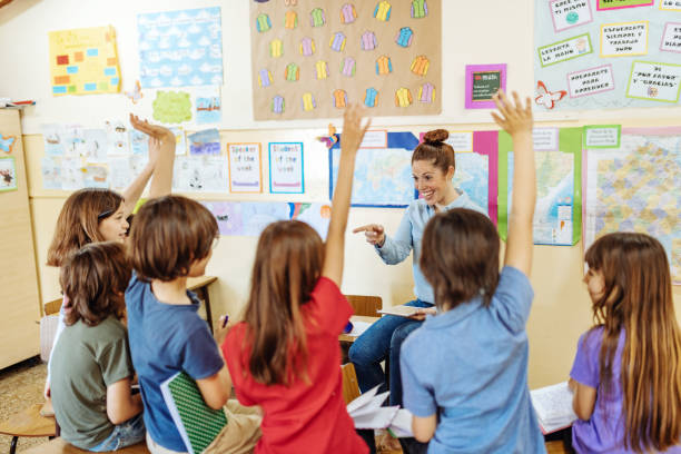 istock Teacher motivating kids to be active in classroom after coronavirus lockdown 1252770775