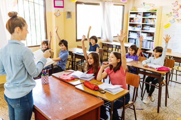 istock Elementary education: pupils writing in theirs notebooks in classroom 1252770918