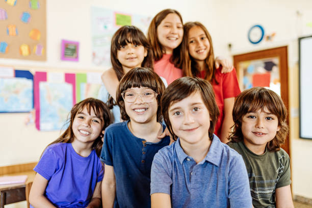 istock Elementary education in Latin America - pupils writing in theirs notebooks in classroom 1252770920