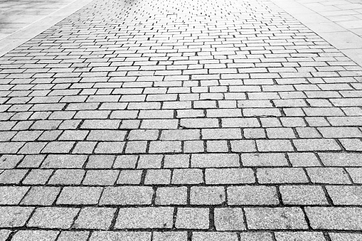 Cobblestone road, black and white, abstract background with copy space, full frame horizontal composition
