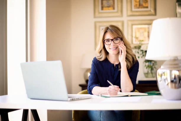 istock Smiling mature woman working at home 1252775269