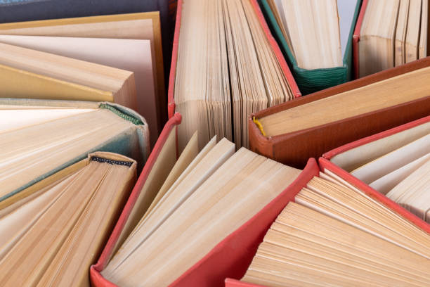istock Many different old hardcover physical books close-up background with selective focus and blur 1252784578