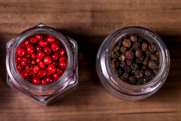 istock Glass jars with black and red peppercorns 1252786170