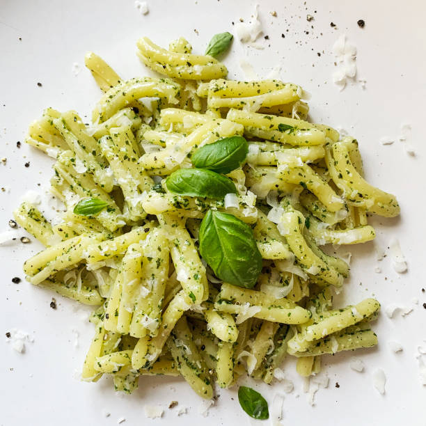 Homemade Casarecce pasta with basil pesto