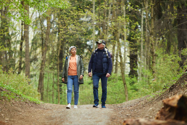 istock Senior Couple Enjoying Walk in Forest 1252788189