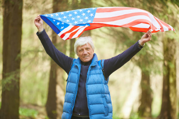 istock Active Senior Man Holding American Flag in Forest 1252788210