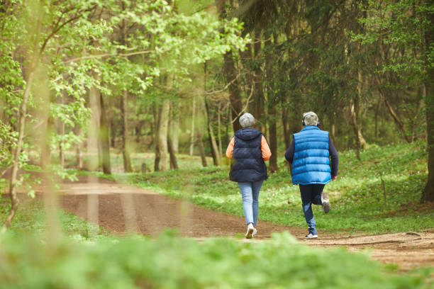 istock Active Senior Woman Running in Forest Back View 1252788247
