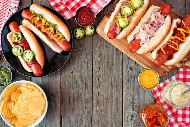 istock BBQ hot dog frame, overhead view table scene on a dark wood background 1252793974