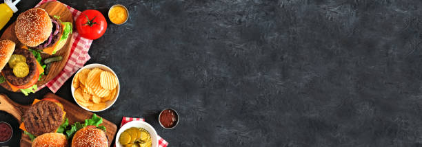 istock BBQ hamburger corner border, top down view over a dark slate banner background 1252794061
