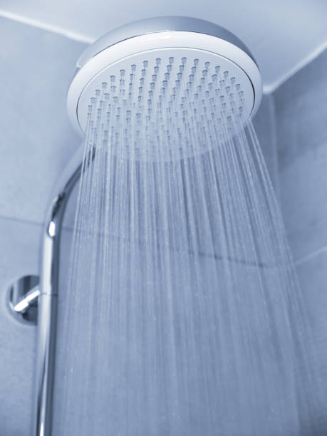 istock Flowing water from shower head at bathroom interior 1252794395