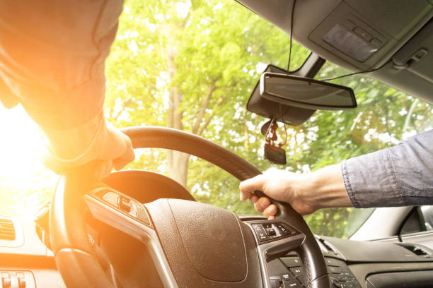 Happy driver inside car at sunset. Young man have fun ride trip travel on road in summer sunny day. Drive vacation concept. Happy driver inside car at sunset. Young man have fun ride trip travel on road in summer sunny day. Drive vacation concept undivided highway stock pictures, royalty-free photos & images