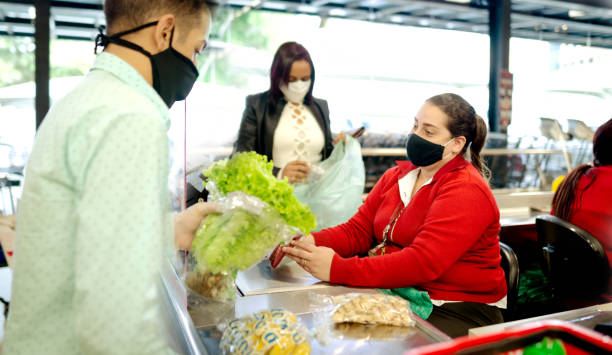 istock Couple shopping at grocery store, using mask 1252795496