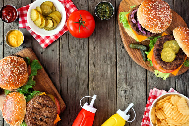 istock BBQ hamburger frame, above view over a dark wood background 1252797016
