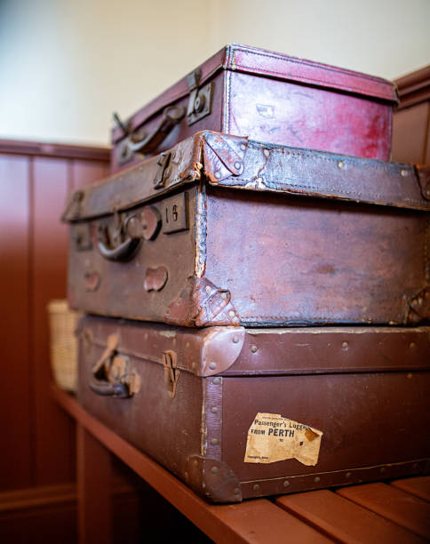 istock Three old suitcases stacked on top of each other 1252797062