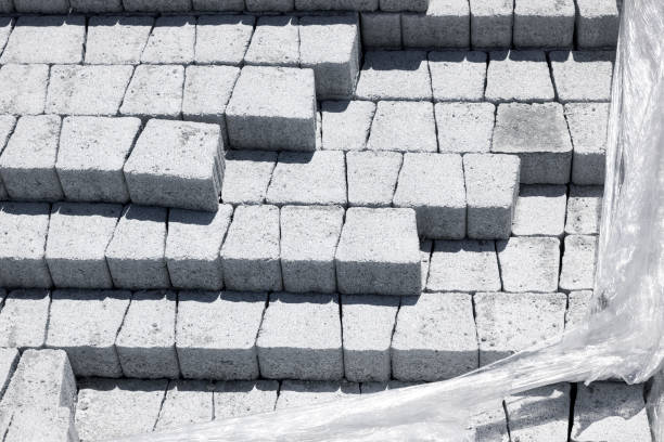 istock Gray paving tiles at a construction site. Material block stored in transparent packaging 1252799628