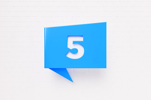 Number five written blue chat bubble over white brick background. Horizontal composition with copy space.