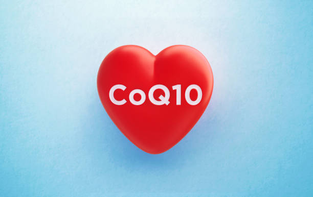 coq10 written red heart shape su sfondo blu - healthy eating red colors healthcare and medicine foto e immagini stock