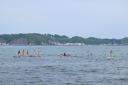 Katsuura, Chiba / Japan - June 13th 2015: Stand Up Paddle Boarding in Japan . a group of foreigners visited Katsuura to take part in a tour around Katsuura bay in front of Mikazuki Hotel.