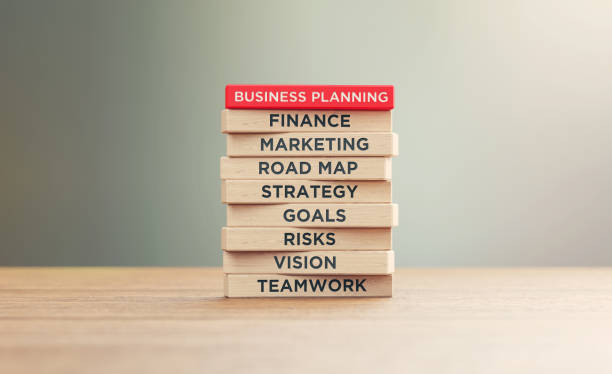 istock Business Planning Related Words Written Wood Blocks Sitting on Wood Surface in Front a Defocused Background 1252802526