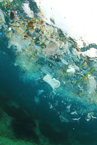 Plastic ocean pollution. Plastic bags and other garbage dumped in sea causing water pollution