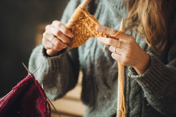 istock Close up on woman's hands knitting 1252803484