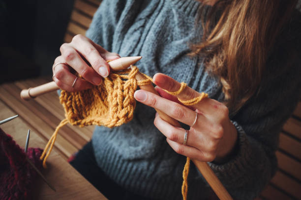 istock Close up on woman's hands knitting 1252803486