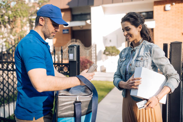 istock Delivery man charging to his customer 1252803529