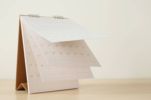 istock Calendar page flipping sheet on wood table background business schedule planning appointment meeting concept 1252803602