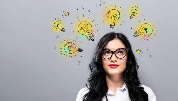 istock Idea light bulbs with young businesswoman 1252809497