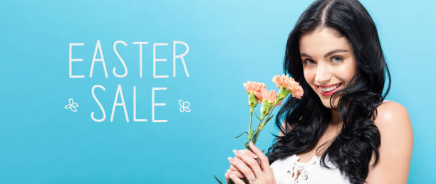 istock Easter sale message with young woman holding carnations 1252809506