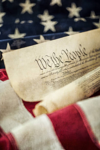 United States Constitution against an Amercian flag background with texture and tone.