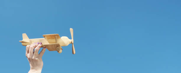 istock Wooden craft biplane model on a sky background 1252815103