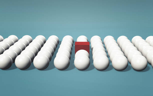 istock Multiple white spheres in a row with a red cube in the middle . Think outside the box concept . Be different . This is a 3d render illustration . 1252822401